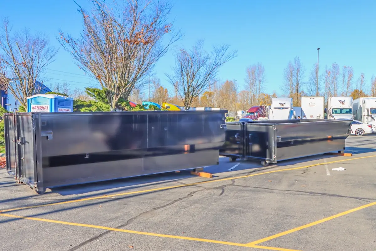 Professional dumpster rental service with roll-off container on residential driveway in Holiday